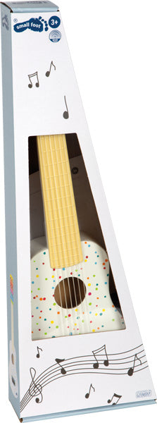 Die Spielzeuggitarre „Gitarre Sound“ mit bunten Punkten wird in einer dreieckigen Schachtel mit Musiknoten geliefert und ist für Kinder ab 3 Jahren geeignet.