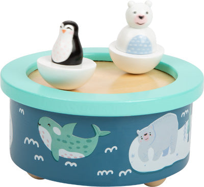 Spieluhr Arktis: Eine runde Spieluhr mit Pinguin- und Eisbärfiguren oben und Illustrationen arktischer Tiere an den Seiten.