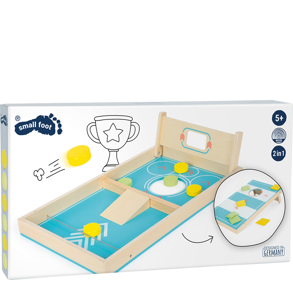 Schachtel für das Cornhole und Sling Puck Spiel „Active“, ein hölzernes Tischspiel mit verschiebbaren gelben Pucks und einem kleinen Tor, geeignet für Kinder ab 5 Jahren.