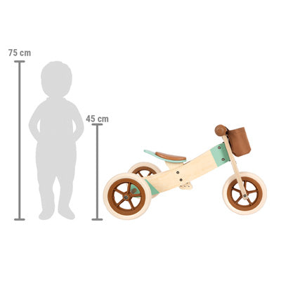 Laufrad und -dreirad Maxi Karamellbraun mit braunen und mintfarbenen Details wird neben einer Kindersilhouette mit Größenangaben gezeigt.