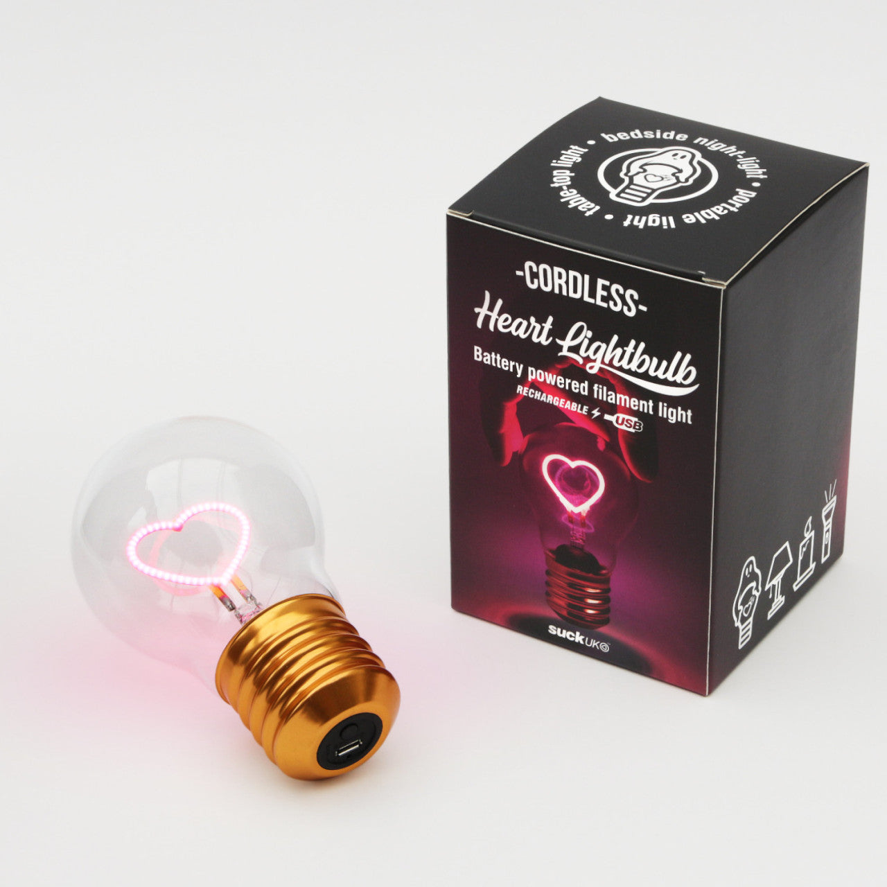 Die kabellose LED-Glühbirne - Herz ist eine kabellose Glühbirne mit einem leuchtend rosa herzförmigen Glühfaden, verpackt in einer Schachtel.