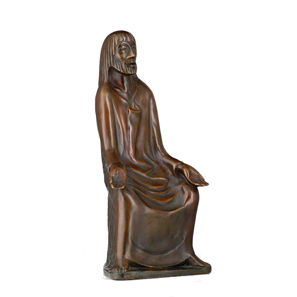 Bronzestatue des „Lehrenden Christus“ von Ernst Barlach. Sie zeigt eine sitzende, langhaarige Figur im Gewand, die eine Hand geöffnet und die andere auf dem Bein ruhend hat.