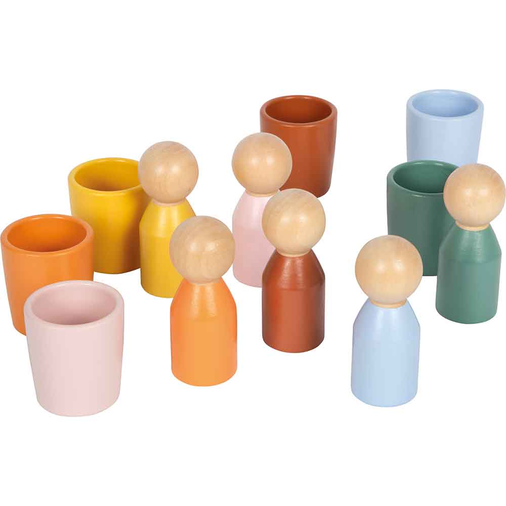 Holzpuppen in verschiedenen Farben stehen neben farblich passenden Tassen, die auf einem weißen Hintergrund angeordnet sind.