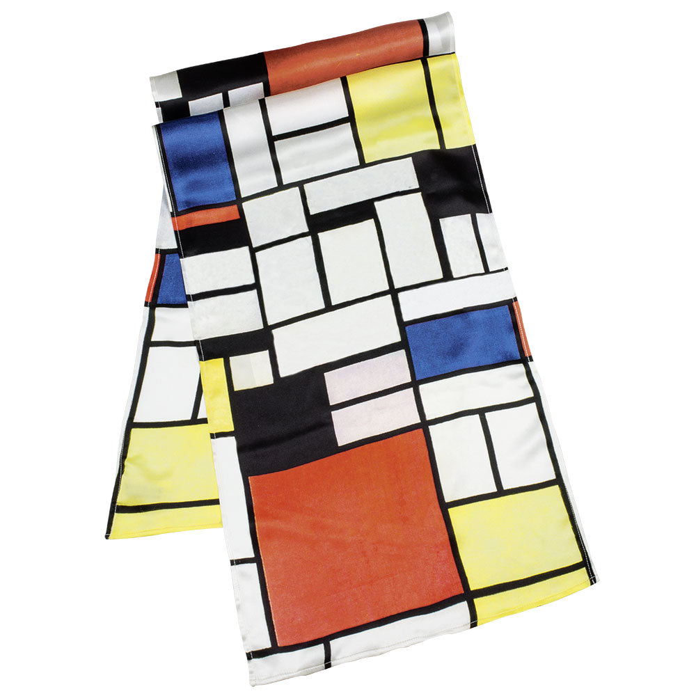 Ein Seidenschal mit einem geometrischen Muster im Mondrian-Stil in Rot, Gelb, Blau, Schwarz und Weiß.