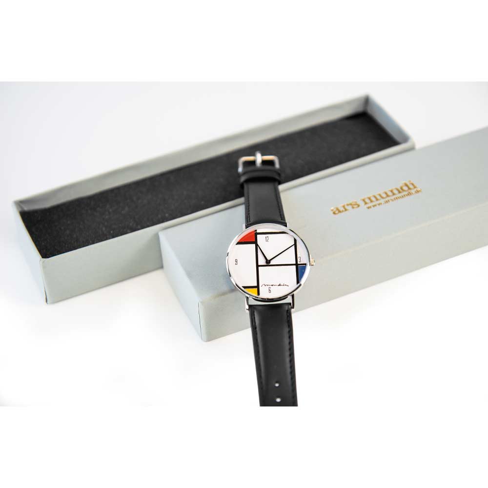 Eine Armbanduhr mit Zifferblatt im Mondrian-Stil und schwarzem Armband, neben einer grauen ars mundi-Box.