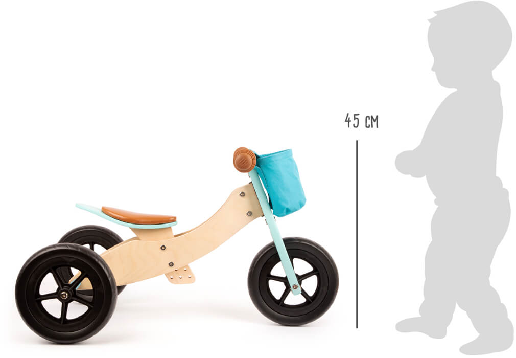 Laufrad und Dreirad Maxi Türkis mit blauer Tasche, abgebildet neben einer Kindersilhouette mit einer Körpergröße von 45 cm.