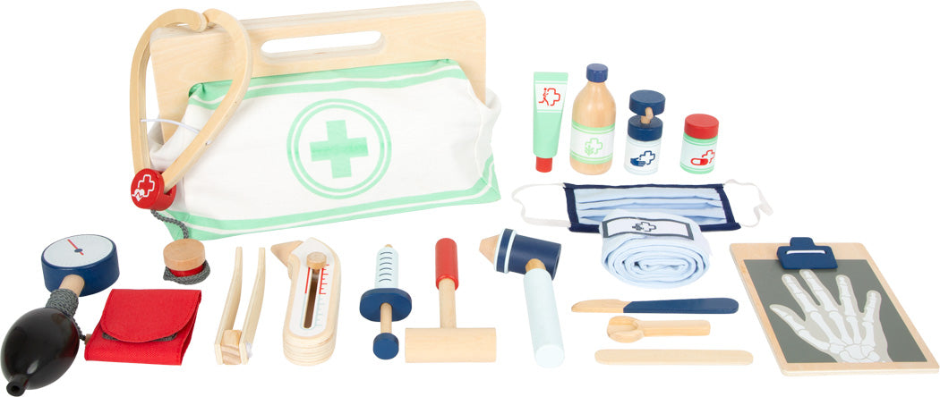 Das Arztkoffer-Set aus Holz „Arzttasche“ enthält medizinische Instrumente, eine Tasche, ein Klemmbrett mit Röntgenbild, Flaschen und eine Maske, alles ordentlich angeordnet.