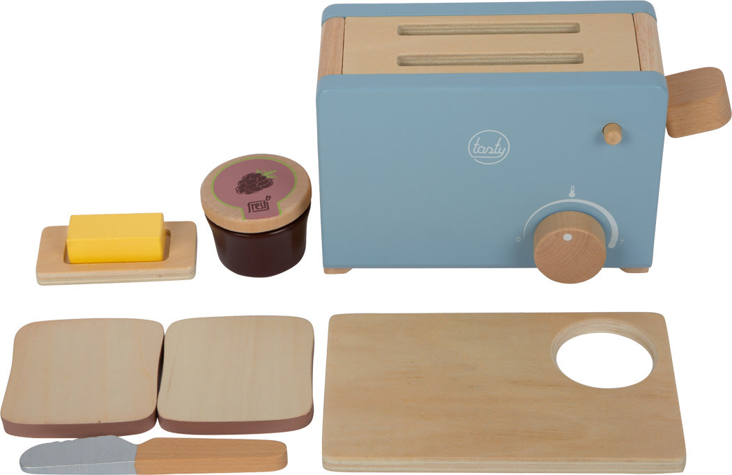 Das Toaster-Set „lecker“ beinhaltet einen Spielzeugtoaster, Holzbrot, Butter, Messer, Marmeladenglas, Teller und ein Schneidebrett, alles auf weißem Hintergrund dargestellt.