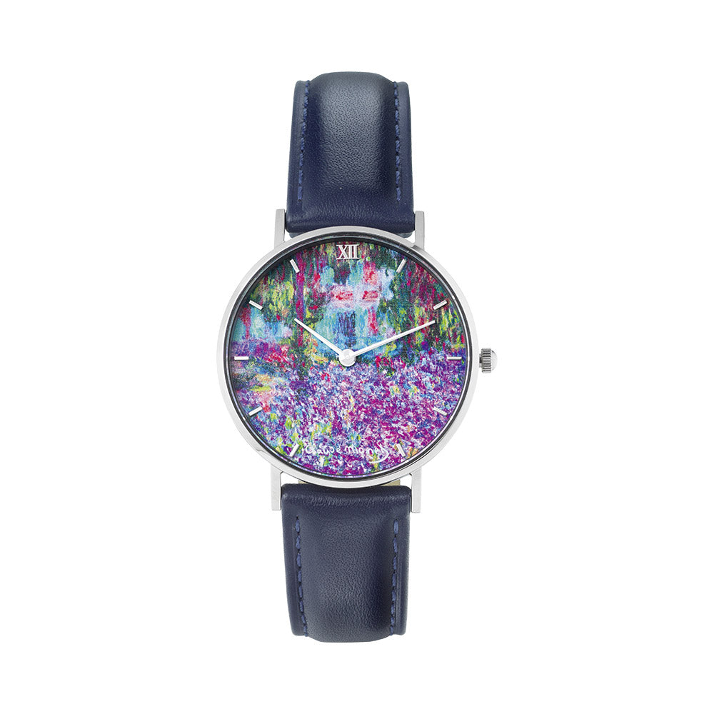 Armbanduhr mit marineblauem Lederarmband und einem farbenfrohen Gartengemälde im impressionistischen Stil auf dem Zifferblatt.