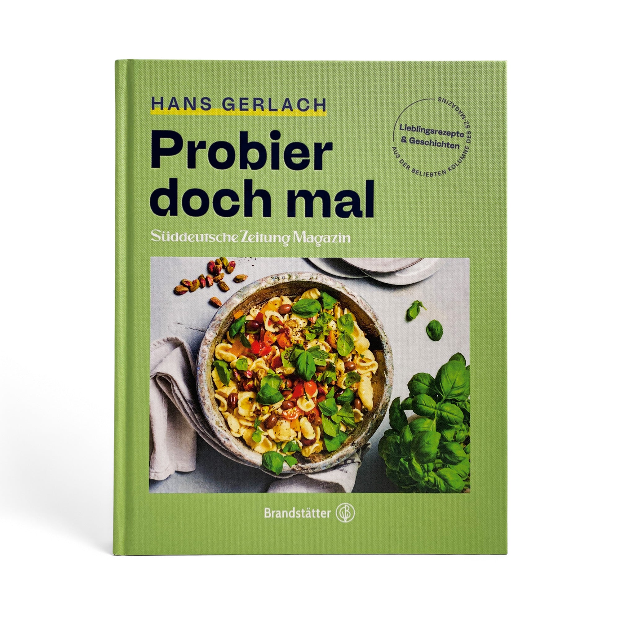 Grünes Kochbuch mit dem Titel „Probier doch mal“ mit einer Schüssel Nudelsalat und frischem Basilikum auf dem Cover.