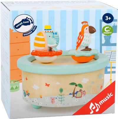 Box mit der „Spieluhr Papagei und Elefant“, einem hölzernen Musikspielzeug mit Elefant und Papagei oben drauf, geeignet für Kinder ab 3 Jahren.