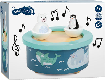 Spieluhr Arktis: Blaue Spielzeugtrommel mit Eisbär- und Pinguinfiguren, mit Meerestieren und Musiknoten auf der Verpackung.