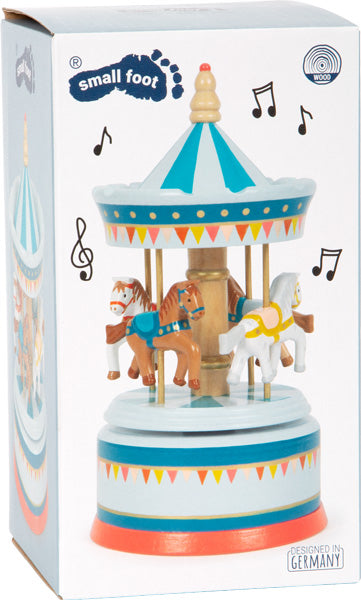 Schachtel mit der Spieluhr Pferdekarussell Zirkus, einem hölzernen Karussellspielzeug mit Pferden und Musiknoten drumherum.
