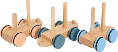 Drei Holzzug „Arctic“-Spielzeugautos aus Holz mit vertikalen Stiften und pastellfarbenen Rädern in Pfirsich, Grün und Blau.