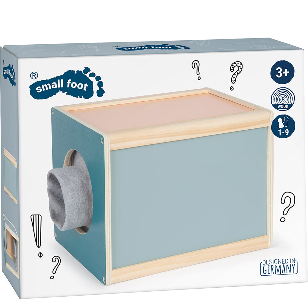 Die Fühlbox „Sensory“ ist eine Spielzeug-Überraschungsbox mit einem stoffbezogenen Loch, beschriftet mit small foot, für Kinder ab 3 Jahren, entworfen in Deutschland.