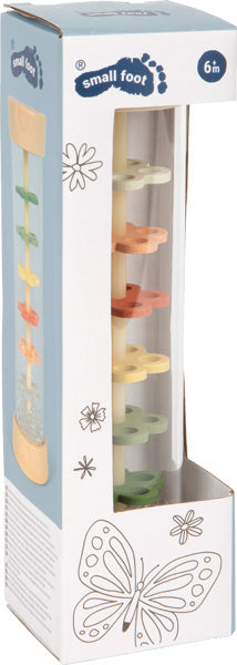 Spielzeug in einer Schachtel mit einer Schmetterlingsillustration, für Kinder ab 6 Monaten.