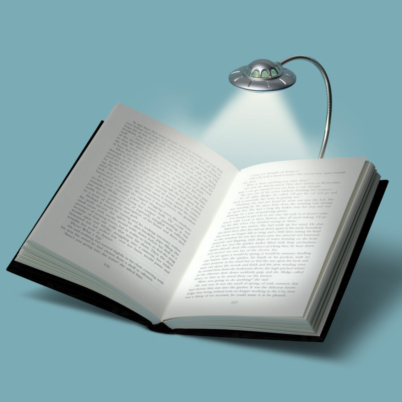 Unter der Leselampe UFO - 3 LEDs liegt ein aufgeschlagenes Buch und wirft Licht auf einen hellblauen Hintergrund.