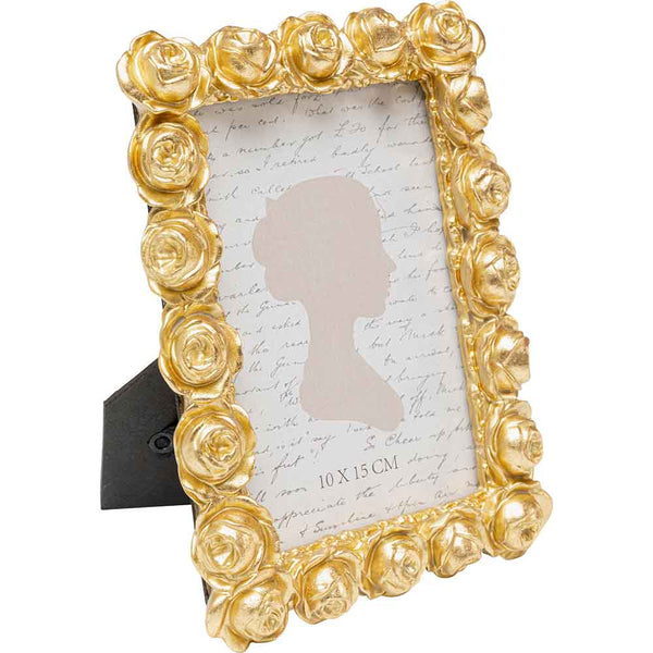 Goldfarbener, rosenverzierter Bilderrahmen mit einer Silhouette und einem Hintergrund in Schreibschrift.