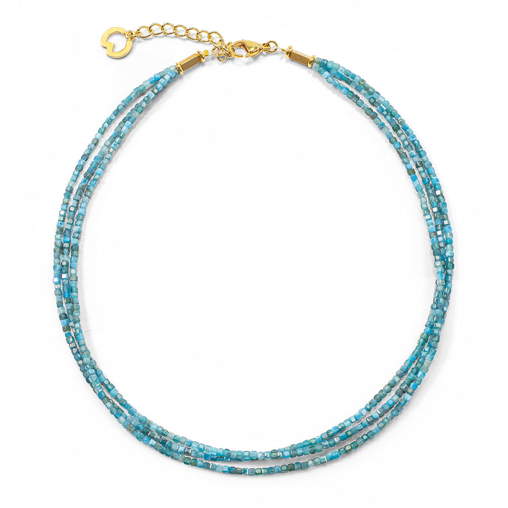 Das Petra Waszak: Collier „Océane“ besteht aus dreireihigen türkisfarbenen Perlen mit einem goldenen Verschluss und einer Verlängerung auf weißem Hintergrund.
