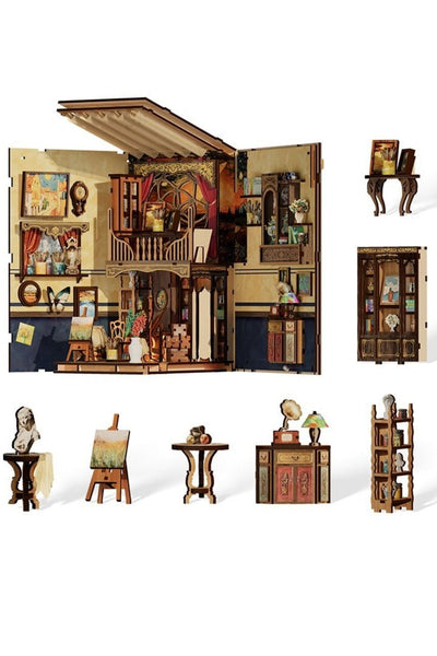 Ein hölzernes Miniatur-Künstleratelier-Diorama mit detaillierten Räumen, Möbeln, Kunstzubehör und Einzelteilen wie Regalen, Tischen, Staffelei und Skulpturen, alles vor einem weißen Hintergrund.