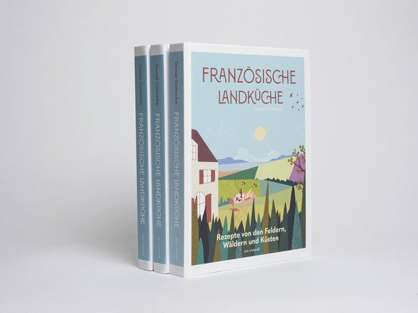 Gezeigt werden drei Exemplare des Buches Französische Landküche mit einem illustrierten Landschaftsumschlag.