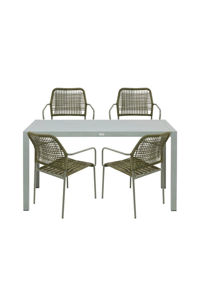 Ein rechteckiger weißer Tisch mit vier passenden Stühlen mit Metallrahmen und geflochtenen Sitzflächen und Rückenlehnen, die um den Tisch herum angeordnet sind.