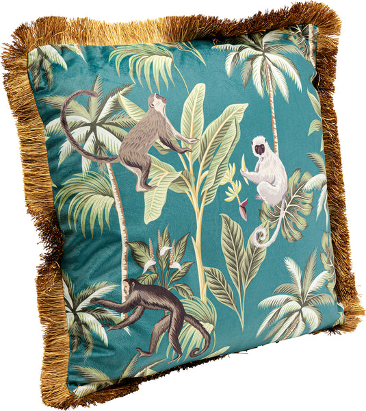 Quadratisches Kissen mit goldenen Fransen, tealfarbenem Hintergrund und einem tropischen Druck mit Affen und Palmenblättern.