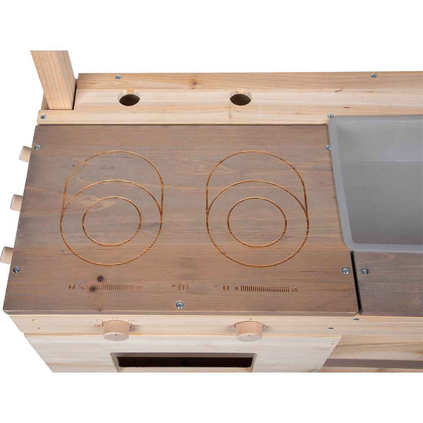 Holzarbeitsplatte für die Spielküche mit zwei geschnitzten Herdplatten, Bedienknöpfen und einem grauen Plastikbecken auf der rechten Seite.