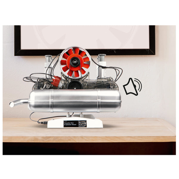 Ein silberner Tischcomputer mit rotem Ventilator und Lautsprechersymbol, der auf einem Holztisch steht.