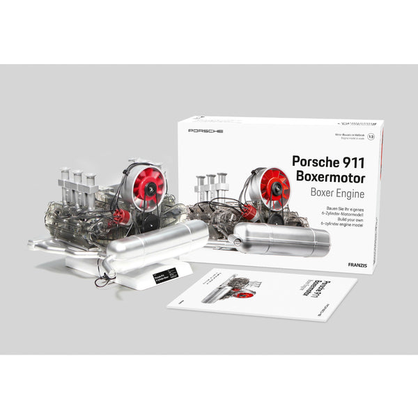 Modell Porsche 911 Boxer-Motor mit roten Ventilatoren, neben seiner Box und Bedienungsanleitung auf einem weißen Hintergrund angezeigt.