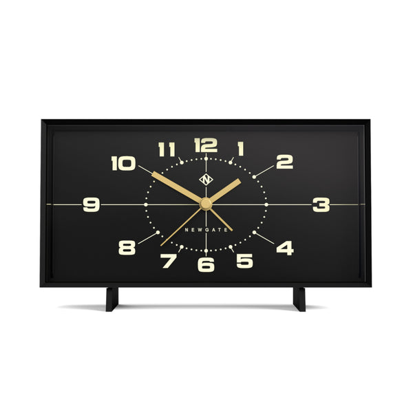 Rechteckige schwarze Uhr mit goldenen Zeigern und Zahlen, Anzeige 10:08, auf zwei kleinen Beinen stehend.