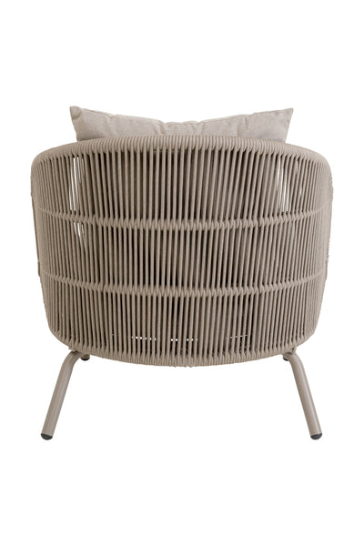 Ein beigefarbener, geflochtener Loungesessel mit geschwungenem Rahmen, vertikalen Seildetails und leichtem Kissen, von hinten gesehen.