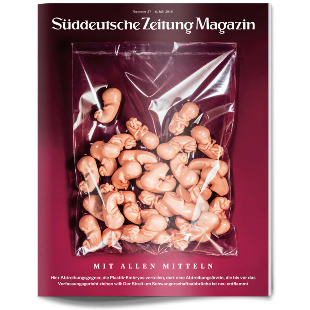 Das Titelbild einer Zeitschrift zeigt Plastikembryonen in einem durchsichtigen Beutel vor einem dunkelroten Hintergrund.