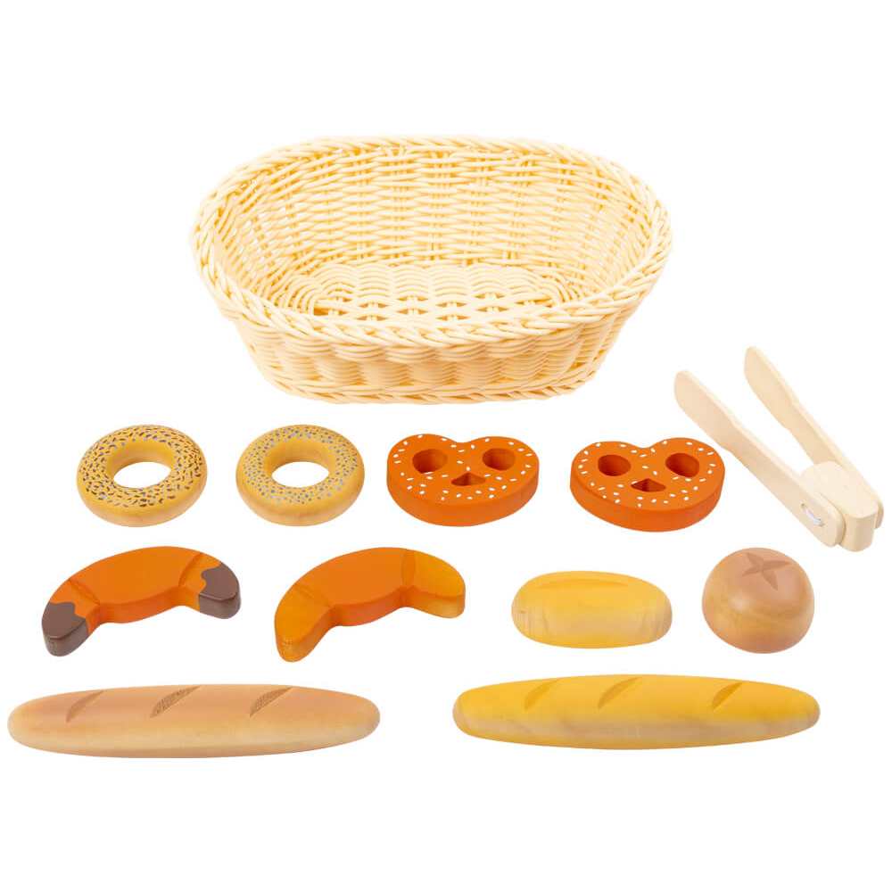 Das Brotkorb-Set „fresh“ beinhaltet einen geflochtenen Korb, eine Zange und eine Auswahl an Holzbroten und Gebäck, alles übersichtlich angeordnet.