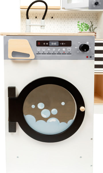 Die Kinderküche modular XL ist eine Spielzeugwaschmaschine mit schwarzer Tür, Bedienfeld und blauer Blasengrafik in der Trommel.