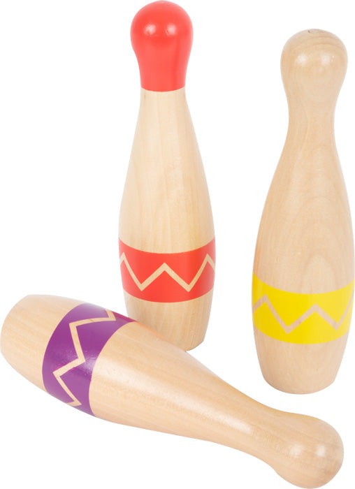 Das Kegelspiel-Set „Active“ besteht aus drei Holzkegeln mit bunten Zickzack-Streifen – zwei stehende und einer liegende.