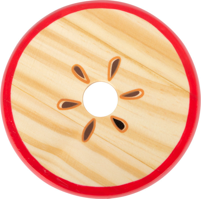 Das Lernspiel Logisteck Apfel ist eine Holzscheibe in Form einer Apfelscheibe mit Kernen und rotem Rand.