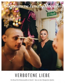 Zwei Personen in einer Umkleidekabine; die eine schminkt sich vor einem Spiegel, die andere steht im Hintergrund in einem Kleid.