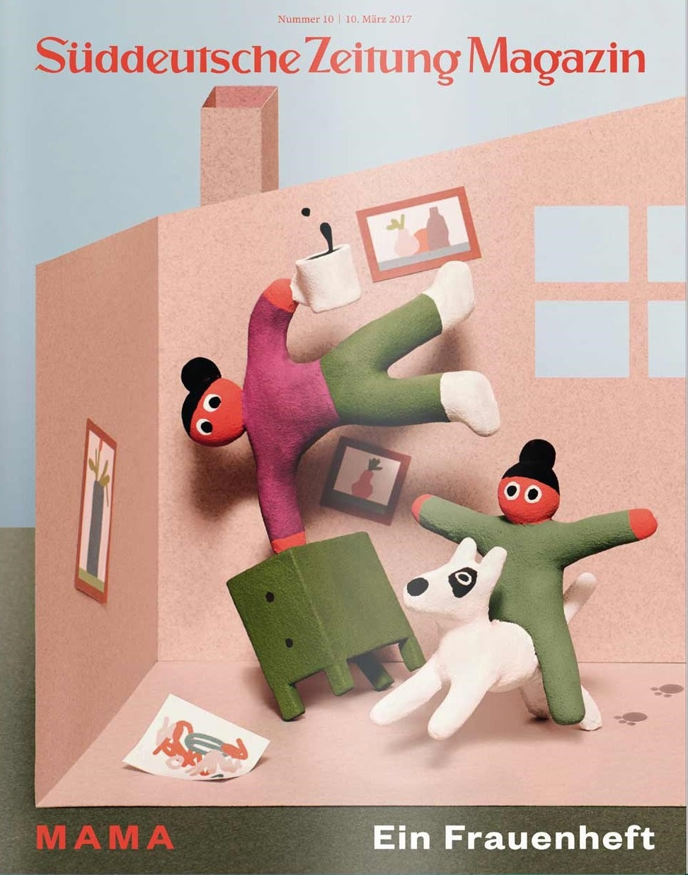 Zwei Tonfiguren, ein Hund und ein grüner Block in einem rosafarbenen, puppenhausähnlichen Raum, Magazinumschlag.