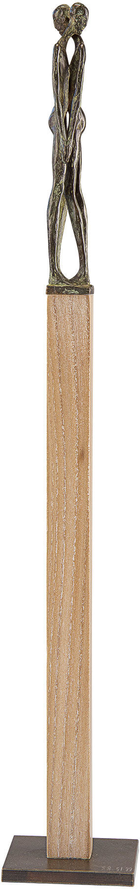 Eine hohe Holzskulptur mit zwei abstrakten menschlichen Figuren, die sich oben umarmen.
