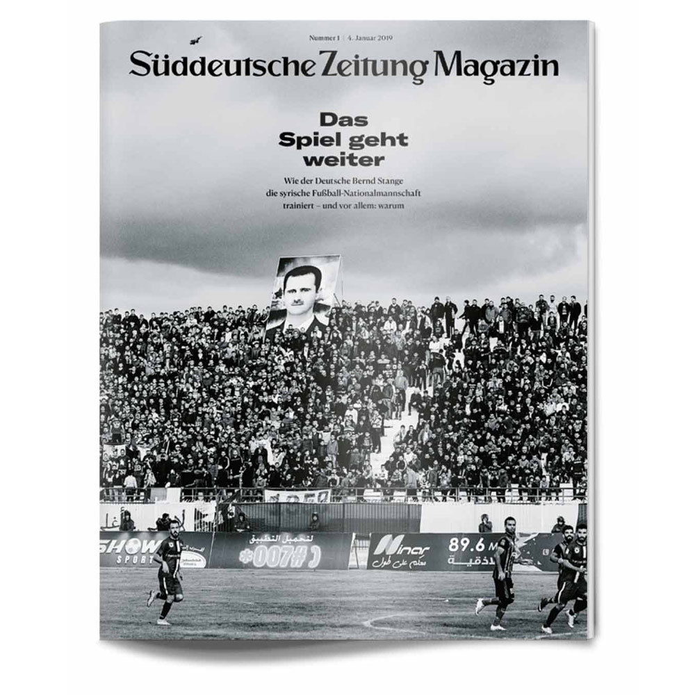 Ein überfülltes Fußballstadion mit einem großen Porträt eines Mannes, Spielern auf dem Spielfeld und einem Magazintext darüber.