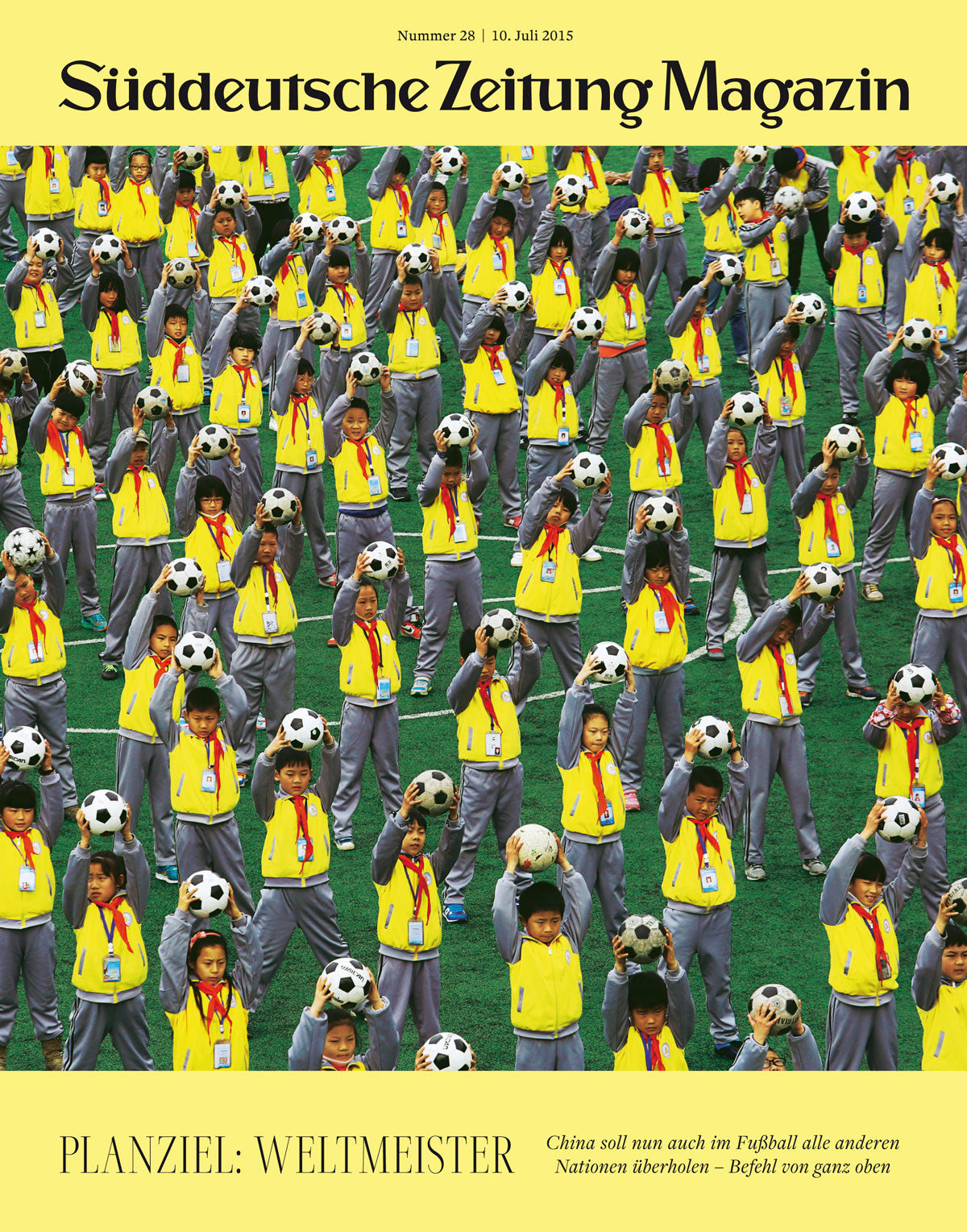 Viele Kinder in gelben Jacken stehen auf der Wiese, jedes hält einen Fußball in der Hand oder trägt ihn auf dem Kopf.